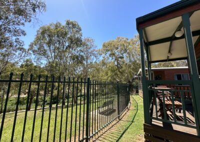 Scenic riverside view with lush greenery at Levi Adelaide Holiday Park.